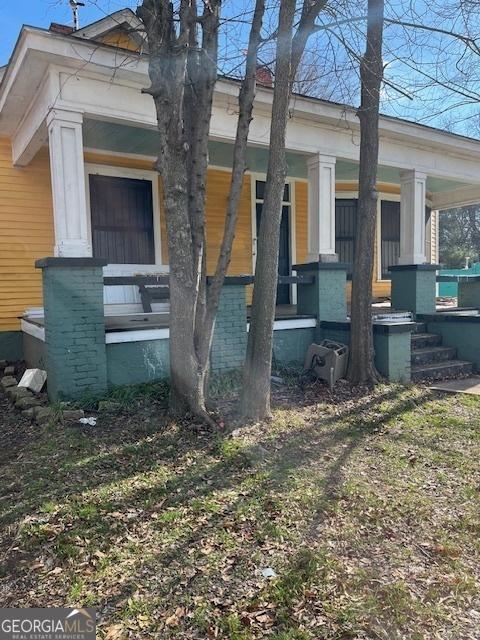 view of side of property with a porch