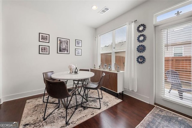 dining space with dark hardwood / wood-style flooring