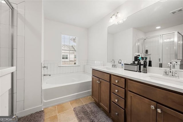 bathroom featuring tile patterned floors, vanity, and plus walk in shower