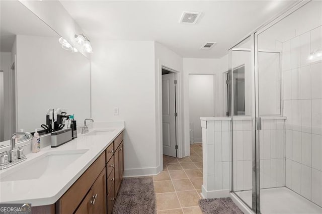 bathroom featuring tile patterned floors, vanity, and an enclosed shower