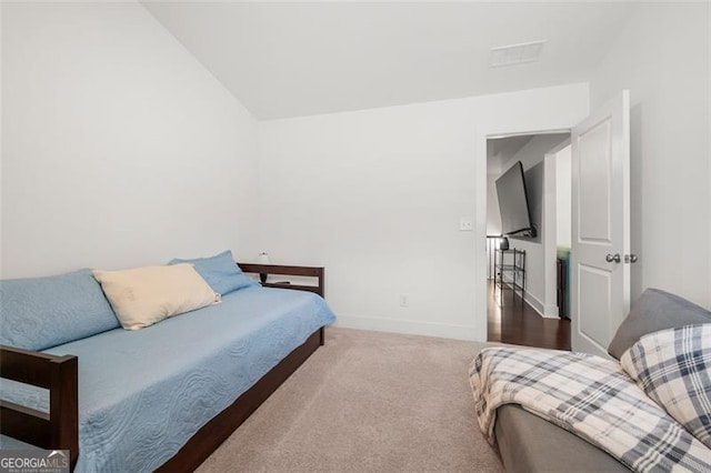 carpeted bedroom featuring vaulted ceiling