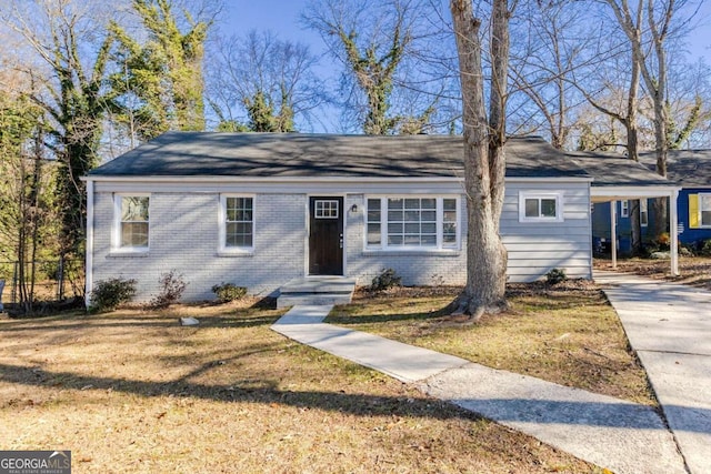 single story home with a carport and a front lawn