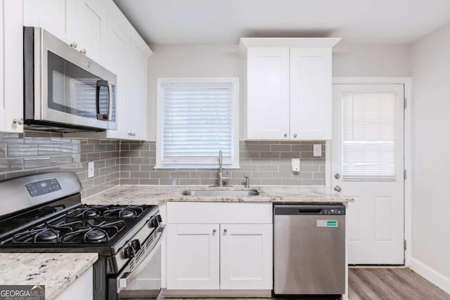 kitchen with white cabinets, appliances with stainless steel finishes, and sink