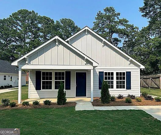 view of front of house with a front yard and a porch