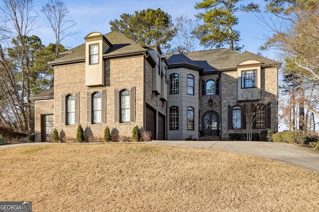 french country style house featuring a garage