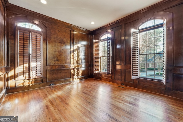 entrance foyer featuring wood walls and wood-type flooring