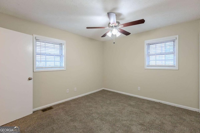 spare room with carpet and ceiling fan