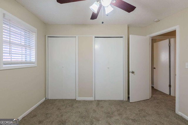 unfurnished bedroom featuring light carpet and ceiling fan