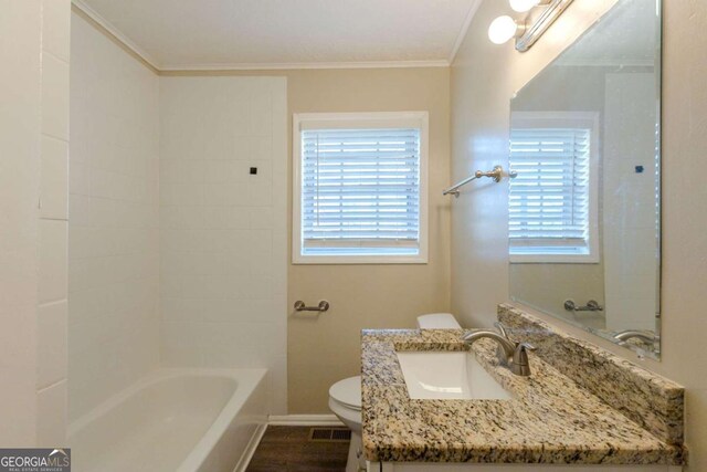 bathroom with crown molding, plenty of natural light, vanity, and toilet