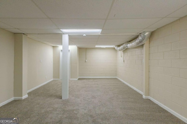 basement with light carpet and a drop ceiling