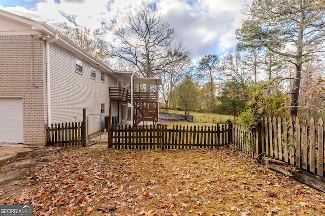 view of yard with a wooden deck and central AC