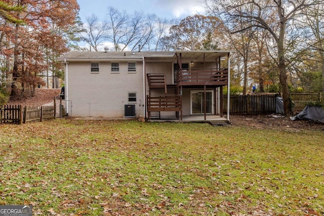 rear view of house featuring cooling unit, a deck, a yard, and a patio