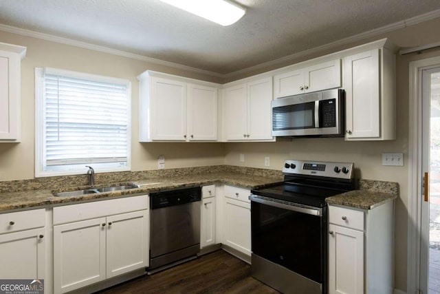 kitchen featuring white cabinetry, sink, and appliances with stainless steel finishes