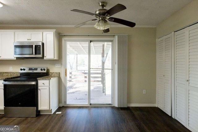 kitchen featuring white cabinetry, stainless steel appliances, and a textured ceiling