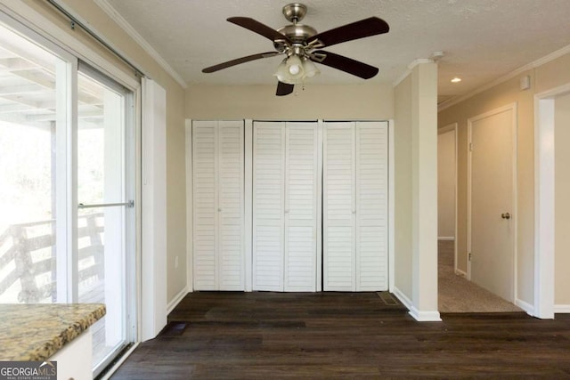 unfurnished bedroom with a textured ceiling, ceiling fan, dark hardwood / wood-style floors, and ornamental molding