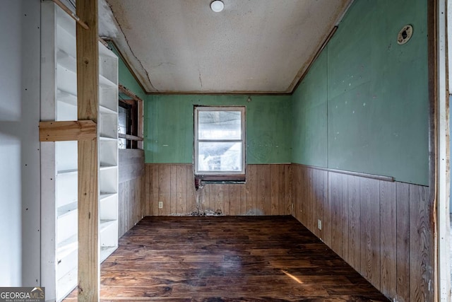 unfurnished room featuring dark hardwood / wood-style flooring and lofted ceiling