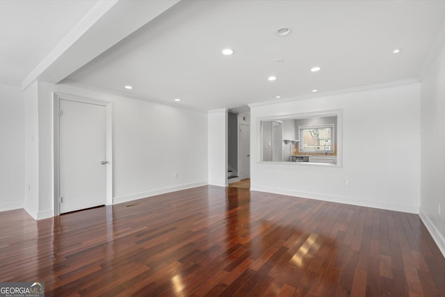 unfurnished living room featuring dark hardwood / wood-style flooring and ornamental molding