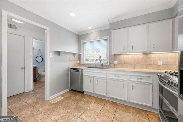 kitchen with backsplash, sink, white cabinets, and appliances with stainless steel finishes