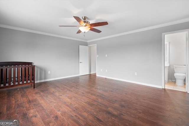 unfurnished bedroom featuring ceiling fan, dark hardwood / wood-style floors, ornamental molding, and connected bathroom