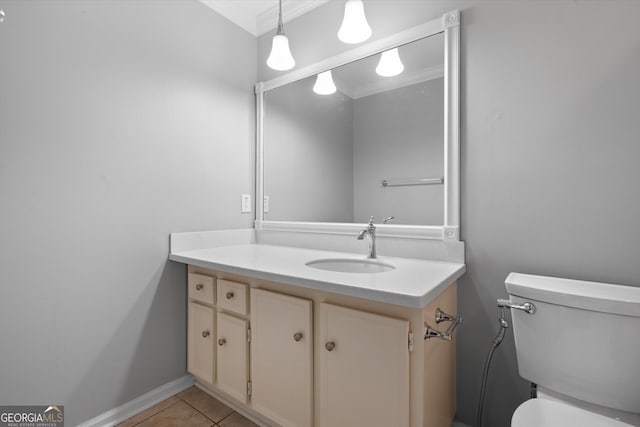 bathroom featuring tile patterned flooring, vanity, toilet, and ornamental molding