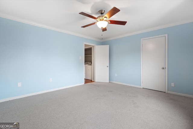 unfurnished room featuring ceiling fan, crown molding, washer / clothes dryer, and light carpet