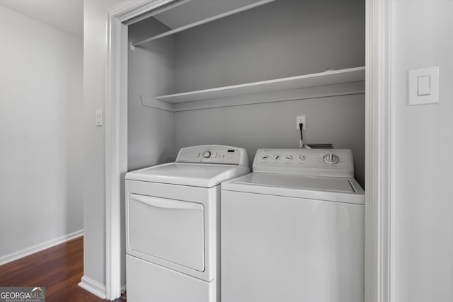 laundry room featuring washer and dryer and dark hardwood / wood-style flooring