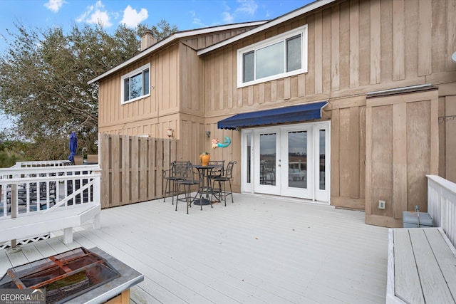 rear view of property with a wooden deck and french doors