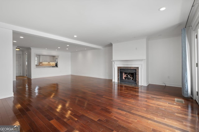 unfurnished living room featuring dark hardwood / wood-style floors