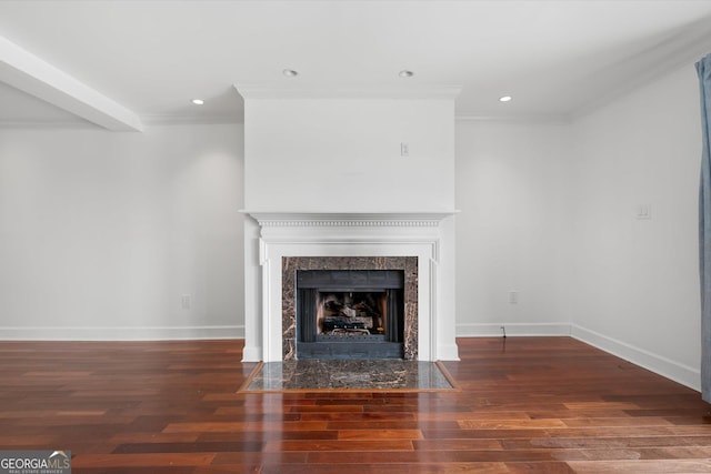 unfurnished living room featuring a high end fireplace, crown molding, and dark wood-type flooring