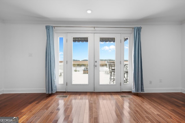 doorway to outside featuring crown molding, french doors, and dark wood-type flooring