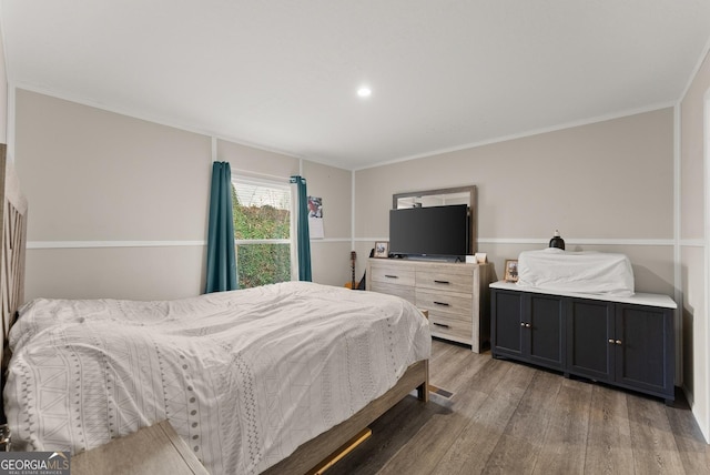 bedroom with wood-type flooring and ornamental molding