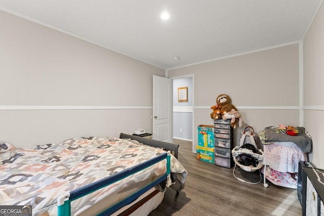 bedroom featuring dark hardwood / wood-style floors and ornamental molding