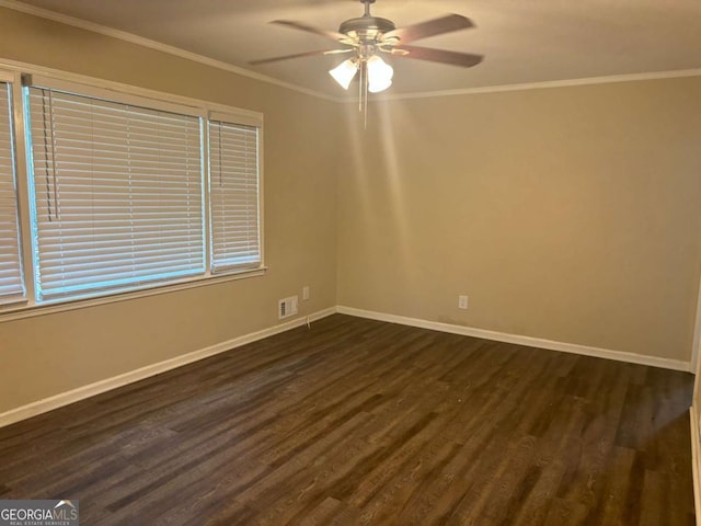 spare room with ceiling fan, dark wood-type flooring, and ornamental molding