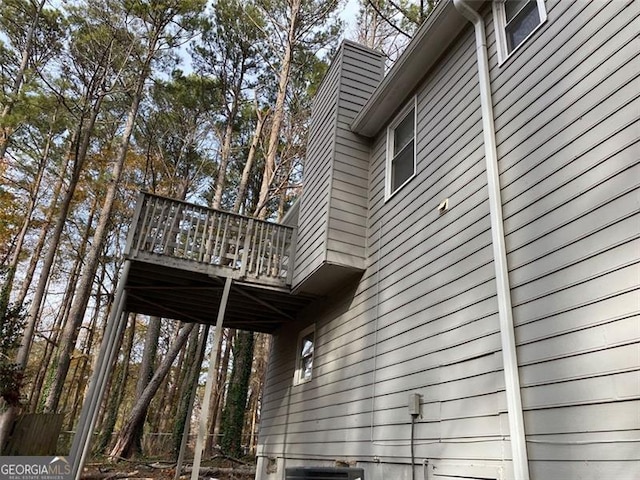 view of property exterior featuring central AC and a balcony