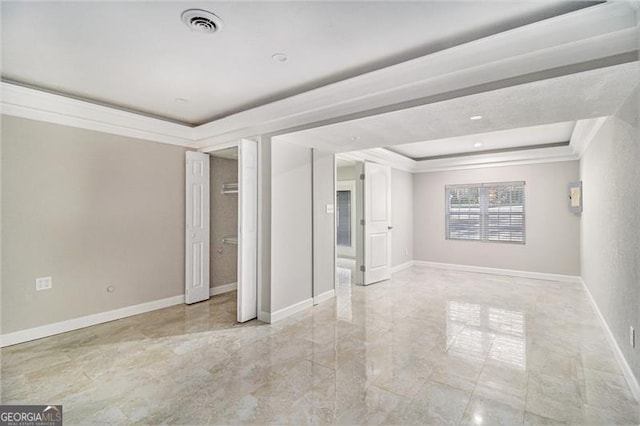 interior space featuring a raised ceiling and ornamental molding