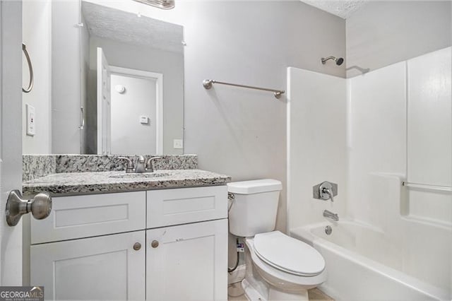 full bathroom with vanity, shower / bath combination, a textured ceiling, and toilet