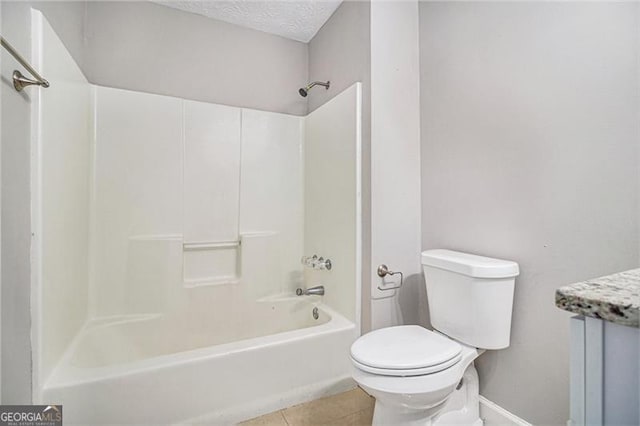 bathroom with shower / bathing tub combination, tile patterned flooring, toilet, and a textured ceiling