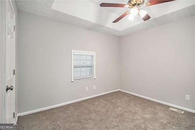 unfurnished room with carpet, ceiling fan, and a textured ceiling