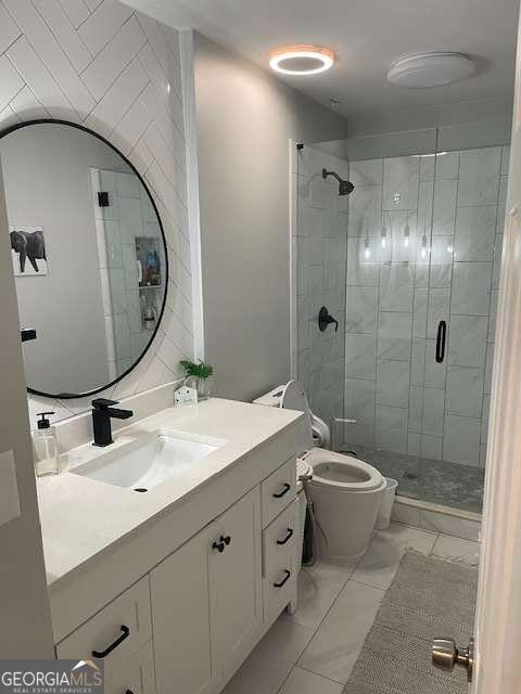 bathroom with tile patterned flooring, vanity, toilet, and walk in shower