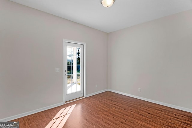 unfurnished room featuring hardwood / wood-style floors