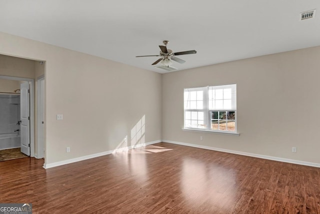 unfurnished room featuring ceiling fan and dark hardwood / wood-style flooring