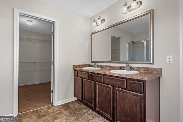 bathroom featuring vanity and an enclosed shower