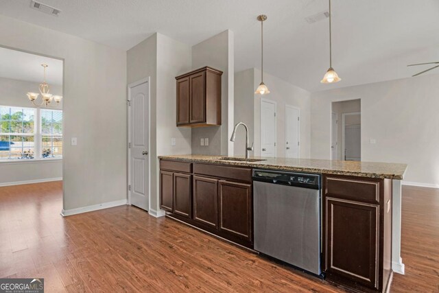 kitchen featuring stainless steel dishwasher, ceiling fan with notable chandelier, dark brown cabinetry, sink, and decorative light fixtures