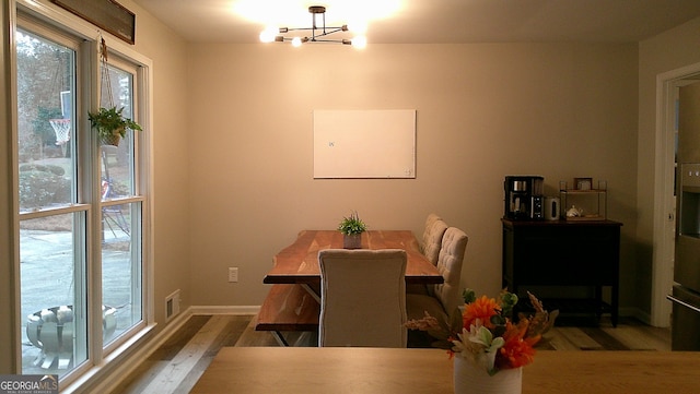 dining room featuring a chandelier and hardwood / wood-style flooring