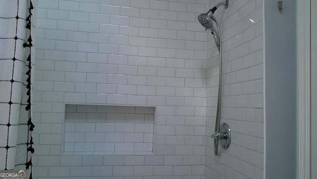 interior details with a tile shower