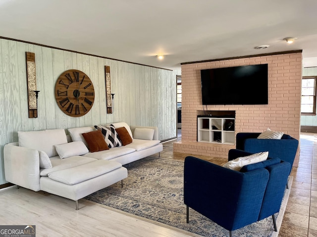 living room with hardwood / wood-style floors and wooden walls