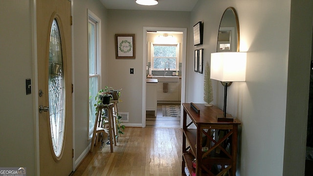 entrance foyer featuring sink and light hardwood / wood-style flooring