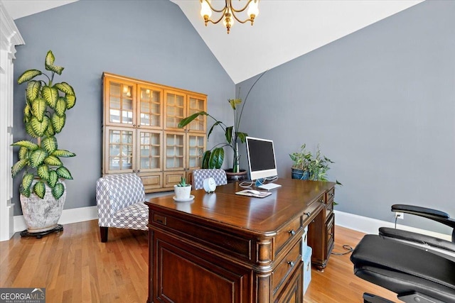 office space featuring light hardwood / wood-style floors, high vaulted ceiling, and a chandelier