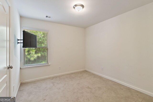 spare room with light carpet
