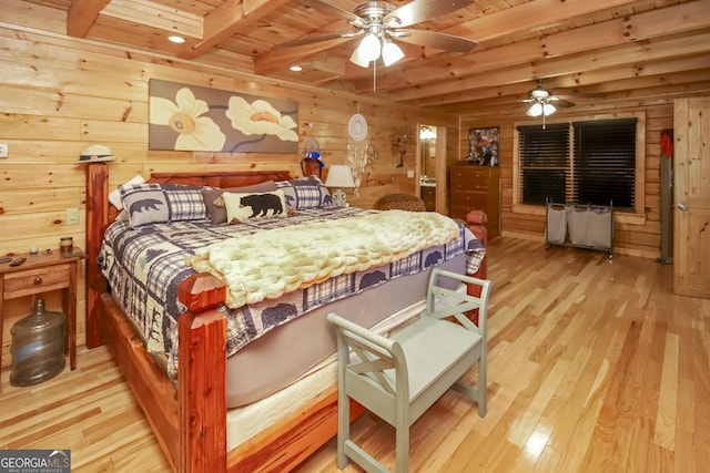 bedroom featuring wood walls, wooden ceiling, light hardwood / wood-style flooring, ceiling fan, and beamed ceiling